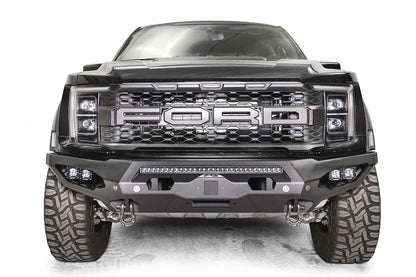 Fab Fours Matrix front bumper on a gray Ford F-150 Raptor, straight-on front view, showing the center light bar, winch plate opening and pod light pockets