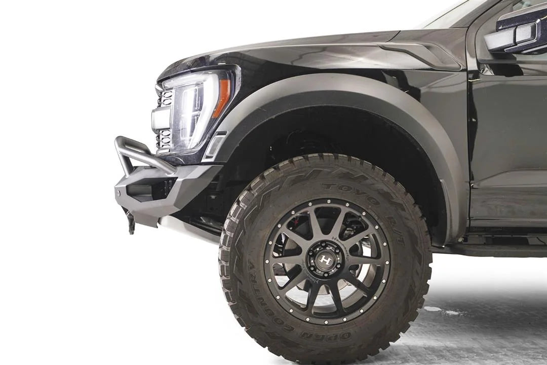 Fab Fours Matrix front winch bumper with pre-runner guard on a gray Ford F-150 Raptor, close-up of the front corner, showing the pre-runner tube end, bumper wing and fender clearance