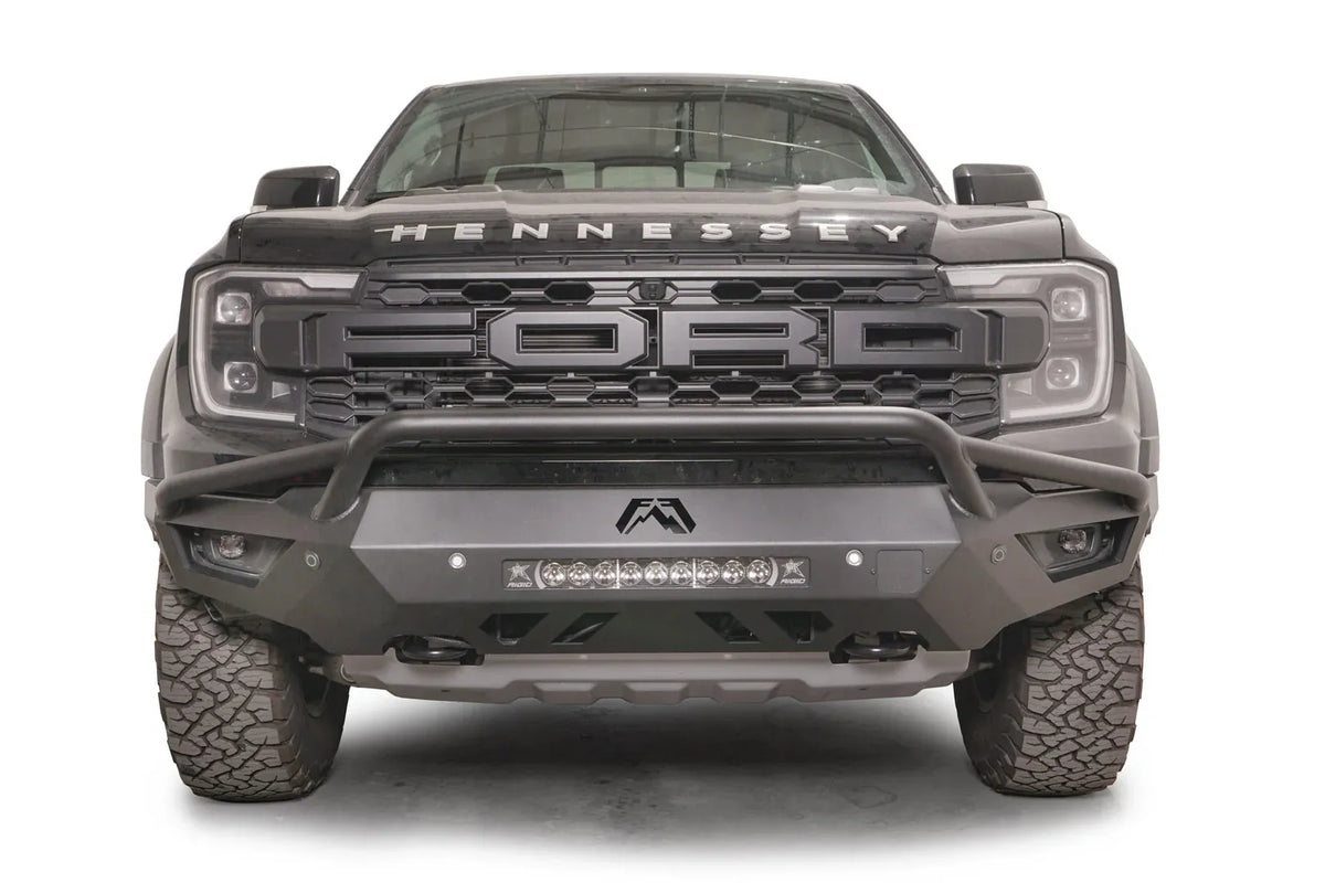 Fab Fours Vengeance front bumper with pre-runner guard on a gray Ford Ranger Raptor, straight-on front view, showing the tubular pre-runner hoop, center light bar and Fab Fours logo cutout