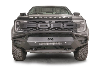 Fab Fours Vengeance front bumper with pre-runner guard on a gray Ford Ranger Raptor, straight-on front view, showing the tubular pre-runner hoop, center light bar and Fab Fours logo cutout