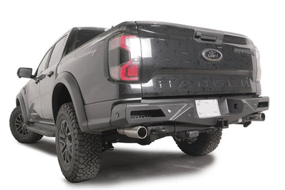 Fab Fours Vengeance rear bumper with honeycomb mesh light openings and parking sensors on a dark gray Ford Ranger Raptor, driver-side rear three-quarter view