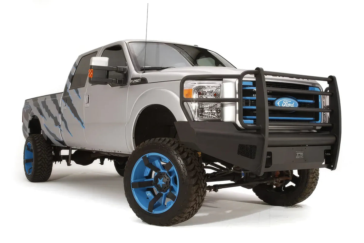 Fab Fours Black Steel Elite front bumper with full guard on a silver Ford Super Duty, front passenger-side three-quarter view, showing the full grille guard, headlight hoops and bumper wing