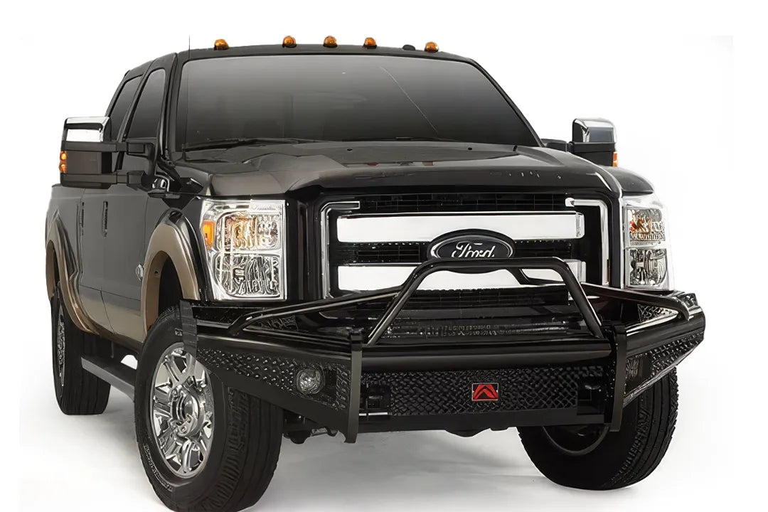 Fab Fours Black Steel front ranch bumper with pre-runner guard on a black and tan Ford Super Duty, front three-quarter view, showing the tubular pre-runner hoop, diamond-plate face and center logo plate