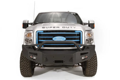 Fab Fours Premium Heavy Duty winch front bumper with pre-runner guard on a silver Ford Super Duty, straight-on front view, showing the tubular pre-runner hoop, winch opening and integrated lights