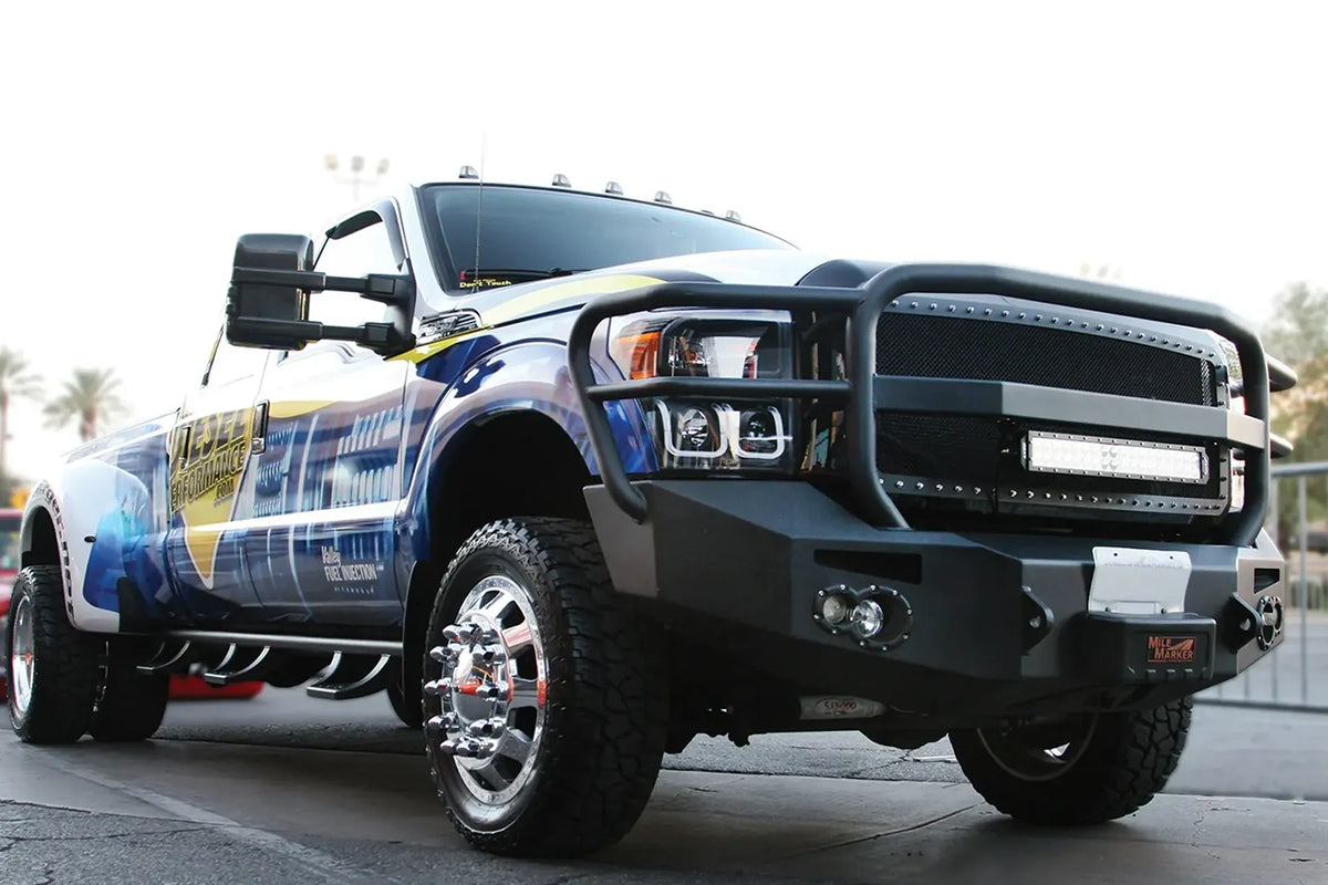 Fab Fours Premium Heavy Duty winch front bumper on a Ford Super Duty, passenger side view outdoors