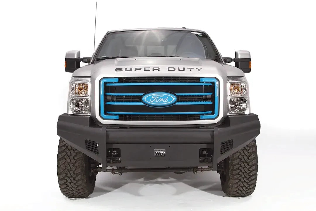 Fab Fours Black Steel Elite front bumper on a silver Ford Super Duty, straight-on front view, showing the smooth plate face, wraparound wings and Elite badge