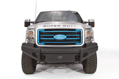 Fab Fours Black Steel Elite front bumper on a silver Ford Super Duty, straight-on front view, showing the smooth plate face, wraparound wings and Elite badge