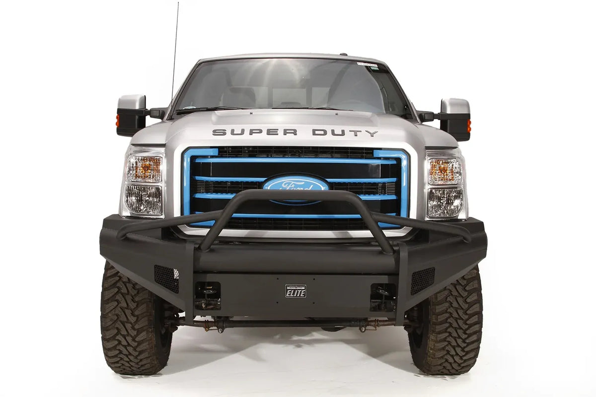 Fab Fours Black Steel Elite front bumper with pre-runner guard on a silver Ford Super Duty, straight-on front view, showing the pre-runner hoop, smooth plate face and Elite badge