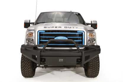 Fab Fours Black Steel Elite front bumper with pre-runner guard on a silver Ford Super Duty, straight-on front view, showing the pre-runner hoop, smooth plate face and Elite badge