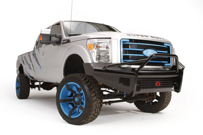 Fab Fours Black Steel front ranch bumper with pre-runner guard on a silver Ford Super Duty, front driver-side three-quarter view, showing the pre-runner hoop, diamond-plate face and bumper wing
