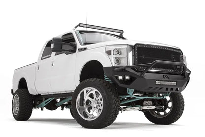 Fab Fours Vengeance front bumper with pre-runner guard on a white Ford Super Duty, front passenger-side three-quarter view, showing the pre-runner hoop, center light bar and pod lights