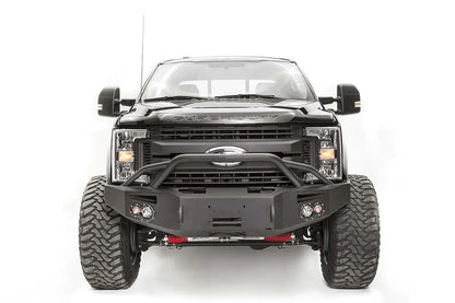 Fab Fours Premium winch front bumper with pre-runner guard on a black Ford Super Duty, straight-on front view, showing the pre-runner hoop, winch opening and pair of integrated lights