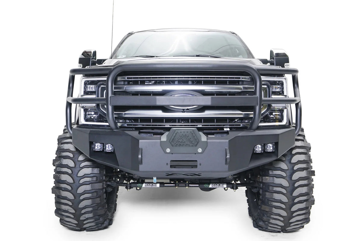 Fab Fours Premium winch front bumper with full guard on a gray Ford Super Duty, straight-on front view, showing the full grille guard, center winch cover and pairs of integrated lights
