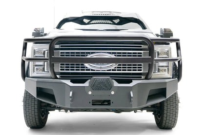 Fab Fours Premium Winch front bumper with full guard on a black Ford Super Duty XL F-450/F-550, straight-on front view, showing full grille guard hoops, the center winch opening, and angular steel end caps