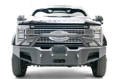 Fab Fours Premium Winch front bumper with pre-runner guard on a black Ford Super Duty XL F-450/F-550, straight-on front view, showing the tubular pre-runner hoop, the center winch opening, and angular steel end caps