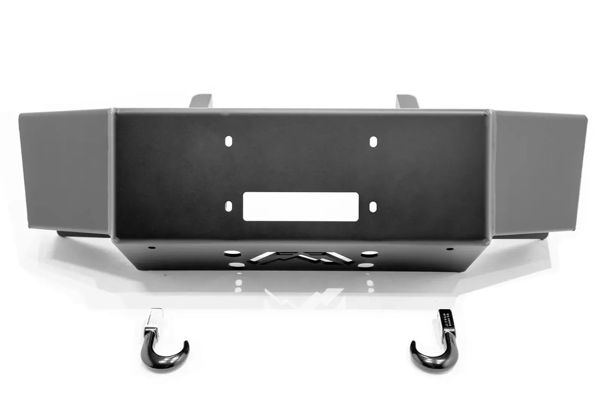Fab Fours winch mount for Ford Super Duty in black powder coat, straight-on front view, showing the winch plate, fairlead opening, and included tow hooks