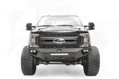 Fab Fours Vengeance front bumper on a black and gray Ford Super Duty F-250/F-350, straight-on front view, showing the center LED light bar, cube light pods, and the open skid plate design