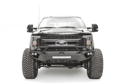 Fab Fours Vengeance front bumper with pre-runner guard on a black and gray Ford Super Duty F-250/F-350, straight-on front view, showing the tubular pre-runner hoop, the center LED light bar, cube light pods, and the open skid plate design
