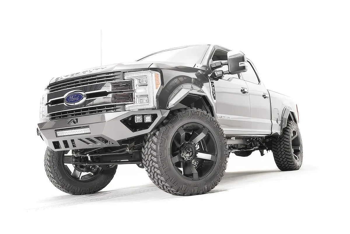 Fab Fours Open Fender front bumper on a gray Ford Super Duty, front driver-side three-quarter view, showing the center LED light bar, cube light pods, and the open-fender wing design