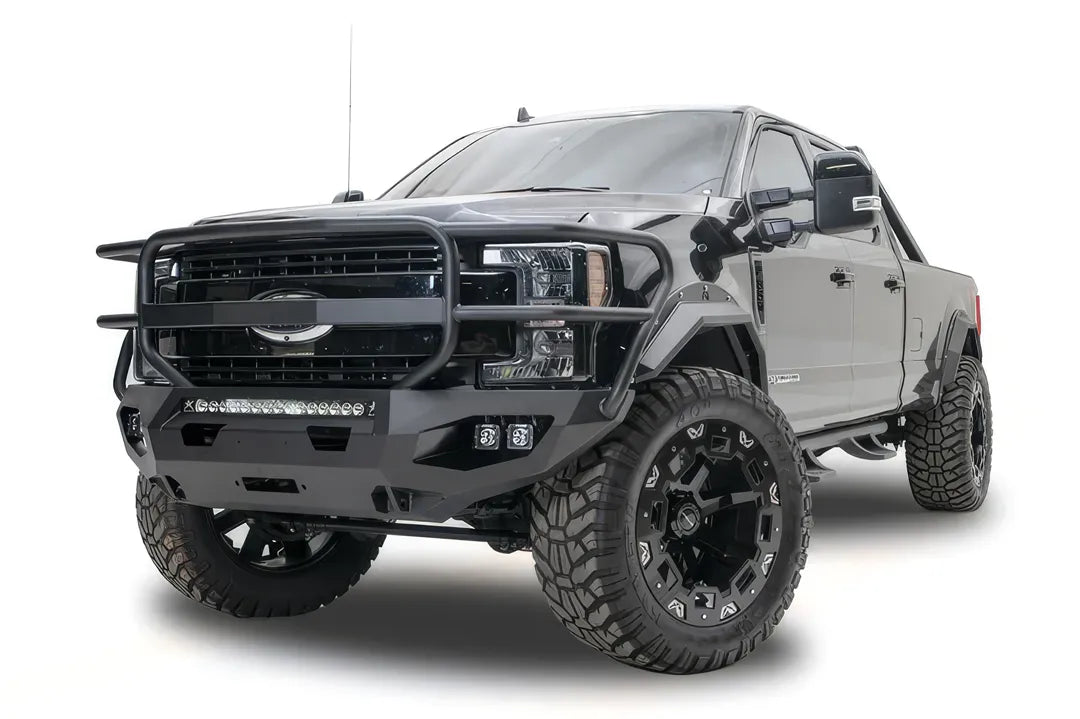 Fab Fours Matrix front bumper with full guard on a black Ford Super Duty F-250/F-350, front driver-side three-quarter view, showing full grille guard hoops, the center LED light bar, cube light pods, and the integrated winch with shackle mounts