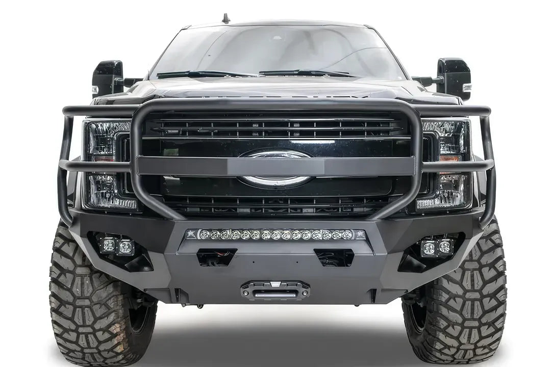 Fab Fours Matrix front bumper with full guard on a black Ford Super Duty F-250/F-350, straight-on front view, showing full grille guard hoops, the center LED light bar, cube light pods, and the integrated winch with shackle mounts