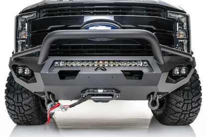 Fab Fours Matrix front bumper with pre-runner guard on a black Ford Super Duty F-250/F-350, straight-on front view, showing the tubular pre-runner hoop, the center LED light bar, cube light pods, and the integrated winch with shackle mounts