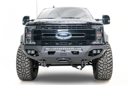 Fab Fours Matrix front bumper on a black Ford Super Duty F-250/F-350, straight-on front view, showing the center LED light bar, cube light pods, and the integrated winch with shackle mounts
