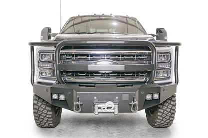 Fab Fours Premium Winch front bumper with full guard on a blue and gray two-tone Ford Super Duty F-250/F-350, straight-on front view, showing full grille guard hoops, the center winch plate with fairlead, LED light pods, and D-ring shackle mounts