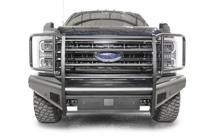Fab Fours Black Steel Elite front bumper with full guard on a blue and gray two-tone Ford Super Duty, straight-on front view, showing full grille guard uprights and side hoops, the smooth steel face, mesh-backed side openings, and the center sensor/plate mount