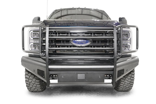 Fab Fours Black Steel Elite front bumper with full guard on a blue and gray two-tone Ford Super Duty, straight-on front view, showing full grille guard uprights and side hoops, the smooth steel face, mesh-backed side openings, and the center sensor/plate mount