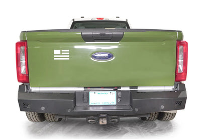 Fab Fours Red Steel rear bumper on a green 2023+ Ford Super Duty dually, rear view showing the matte black bumper 
