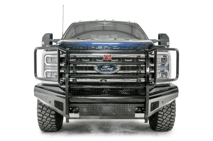 Fab Fours Black Steel front bumper with full guard on a blue and gray two-tone Ford Super Duty, straight-on front view, showing full grille guard with mesh insert, diamond-plate face panels, the center sensor/plate mount, and angled side wings