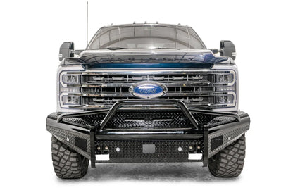 Fab Fours Black Steel front bumper with pre-runner guard on a blue and gray two-tone Ford Super Duty, straight-on front view, showing the tubular pre-runner hoop, diamond-plate face panels, the center sensor/plate mount, and angled side wings