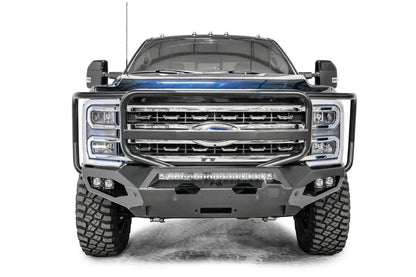 Fab Fours Matrix front bumper with full guard on a gray and dark blue two-tone Ford Super Duty F-250, straight-on front view, showing the full grille guard hoop, LED light bar and center winch fairlead opening