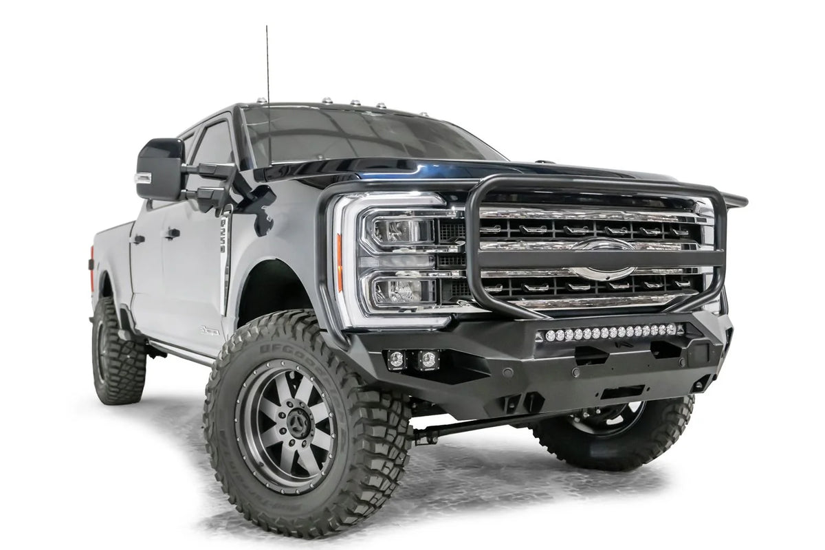 Fab Fours Matrix front bumper with full guard on a gray and dark blue two-tone Ford Super Duty F-250, front passenger-side three-quarter view, showing the full grille guard hoop, LED light bar and cube light pockets