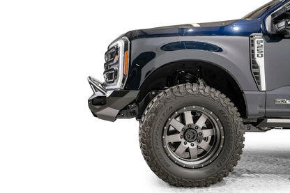 Fab Fours Matrix front bumper with pre-runner guard on a dark blue Ford Super Duty F-250, close-up of the driver-side corner, showing the pre-runner tube end, bumper wing and wheel-well clearance