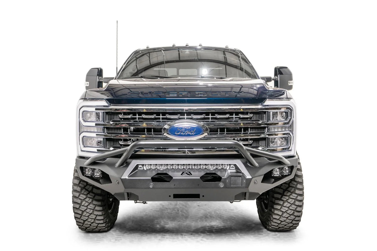 Fab Fours Matrix front bumper with pre-runner guard on a gray and dark blue two-tone Ford Super Duty F-250, straight-on front view, showing the pre-runner hoop, center LED light bar and winch fairlead opening