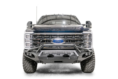 Fab Fours Matrix front bumper with pre-runner guard on a gray and dark blue two-tone Ford Super Duty F-250, straight-on front view, showing the pre-runner hoop, center LED light bar and winch fairlead opening