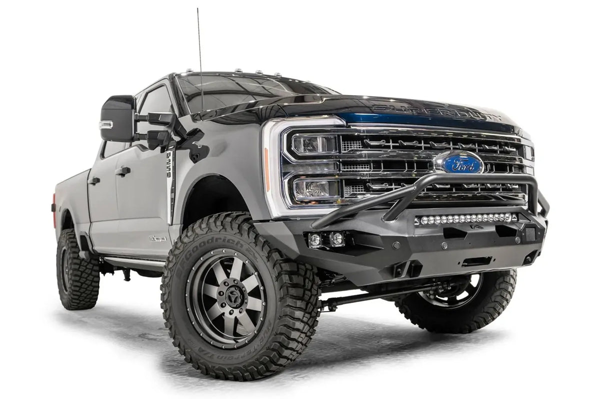 Fab Fours Matrix front bumper with pre-runner guard on a gray and dark blue two-tone Ford Super Duty F-250, front passenger-side three-quarter view, showing the pre-runner hoop, LED light bar and cube light pockets