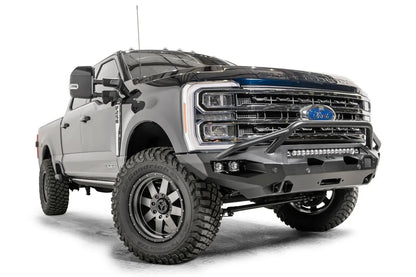 Fab Fours Matrix front bumper with pre-runner guard on a gray and dark blue two-tone Ford Super Duty F-250, front passenger-side three-quarter view, showing the pre-runner hoop, LED light bar and cube light pockets