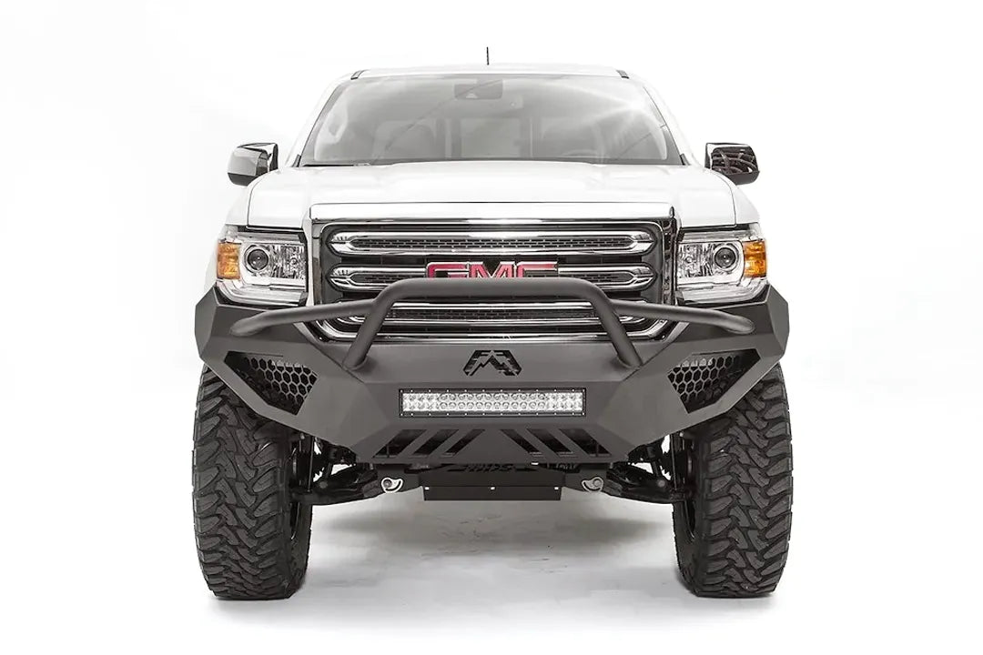 Fab Fours Vengeance front bumper with pre-runner guard on a white GMC Canyon, straight-on front view, showing the pre-runner hoop, center LED light bar and honeycomb light pockets