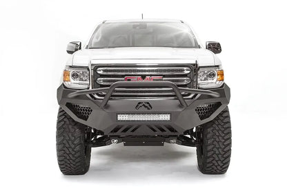 Fab Fours Vengeance front bumper with pre-runner guard on a white GMC Canyon, straight-on front view, showing the pre-runner hoop, center LED light bar and honeycomb light pockets