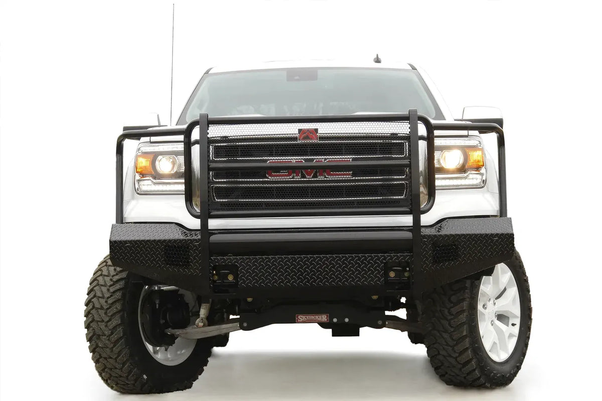 Fab Fours Black Steel front bumper with full guard on a white GMC Sierra 1500, straight-on front view, showing the full grille guard hoops, mesh grille insert and diamond-plate bumper face