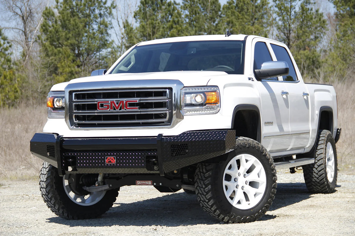 Fab Fours Black Steel front bumper on a white GMC Sierra 1500 parked on gravel, front driver-side three-quarter view, showing the no-guard diamond-plate face, top tube and wrapped wings