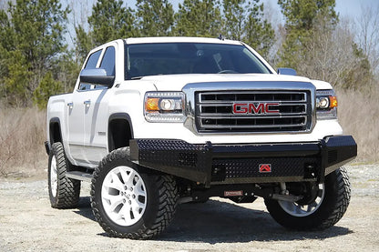 Fab Fours Black Steel front bumper on a white GMC Sierra 1500 parked on gravel, front passenger-side three-quarter view, showing the no-guard diamond-plate face, top tube and wrapped wings