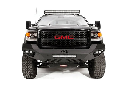 Fab Fours Vengeance front bumper on a black GMC Sierra 2500HD, straight-on front view, showing the sculpted no-guard face, center LED light bar and outboard cube lights