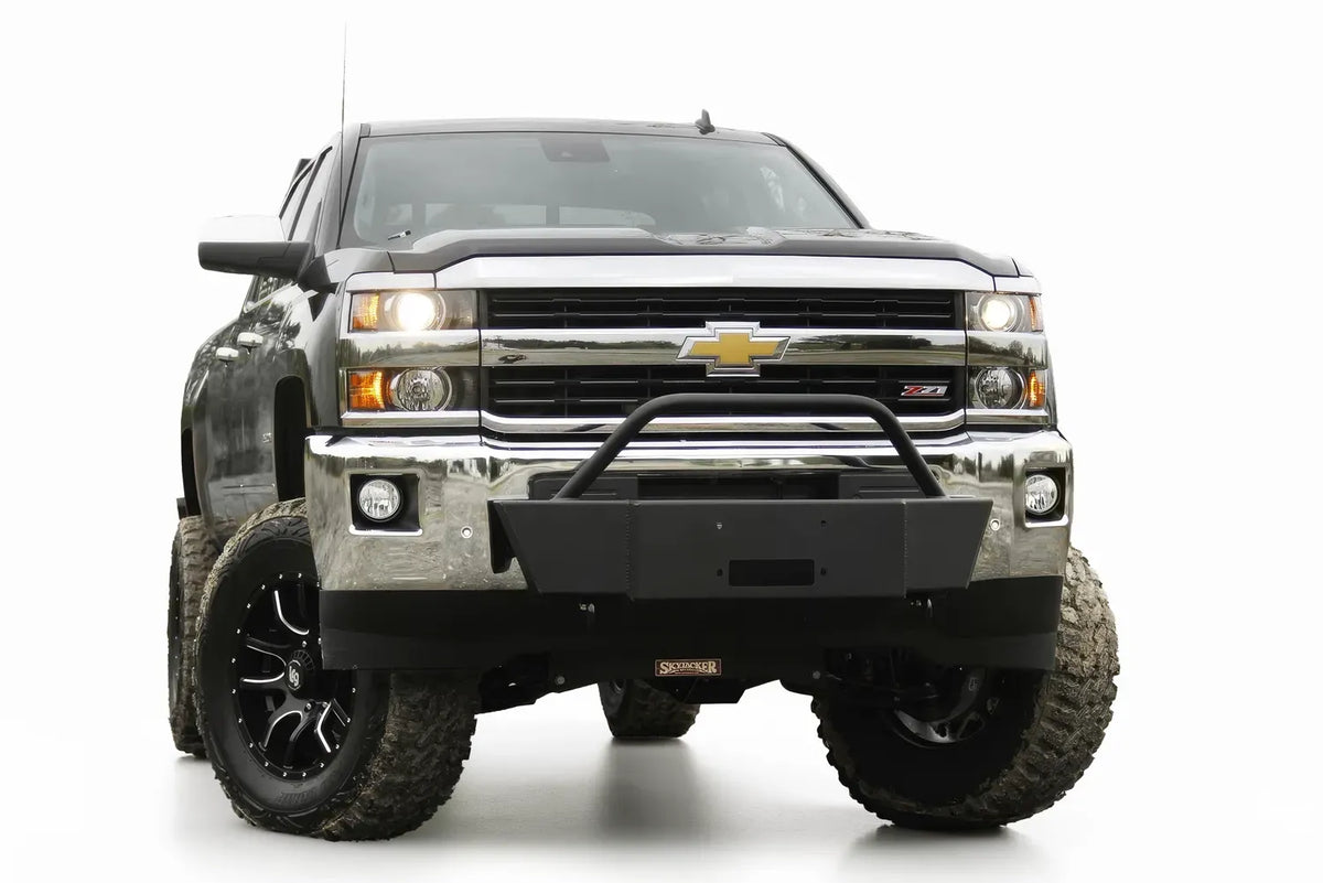 Fab Fours winch mount with pre-runner guard on a black Chevrolet Silverado 2500HD, front view, showing the pre-runner hoop, winch plate and factory chrome bumper integration