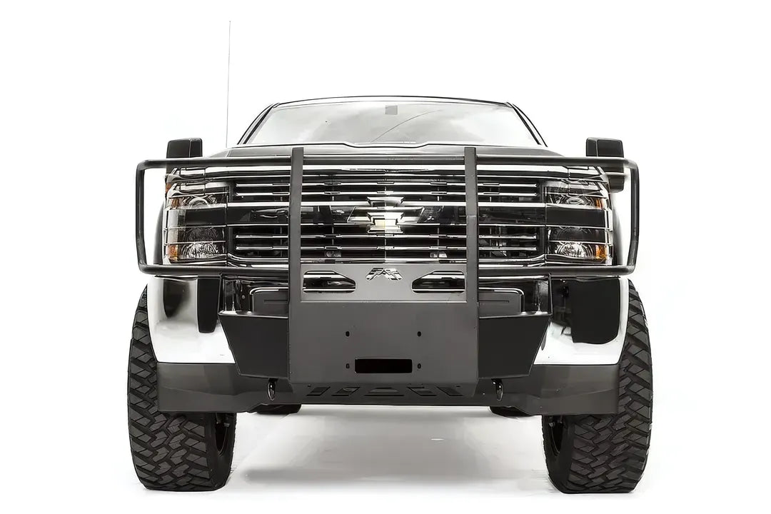 Fab Fours winch mount with full guard on a dark gray Chevrolet Silverado 2500HD, straight-on front view, showing the full grille guard hoop, center winch plate and factory bumper integration