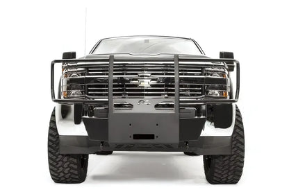 Fab Fours winch mount with full guard on a dark gray Chevrolet Silverado 2500HD, straight-on front view, showing the full grille guard hoop, center winch plate and factory bumper integration