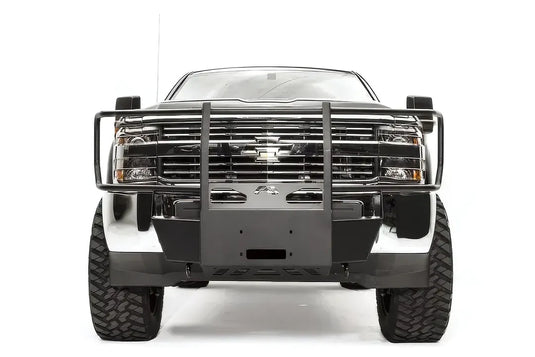 Fab Fours winch mount with full guard on a dark gray Chevrolet Silverado 2500HD, straight-on front view, showing the full grille guard hoop, center winch plate and factory bumper integration